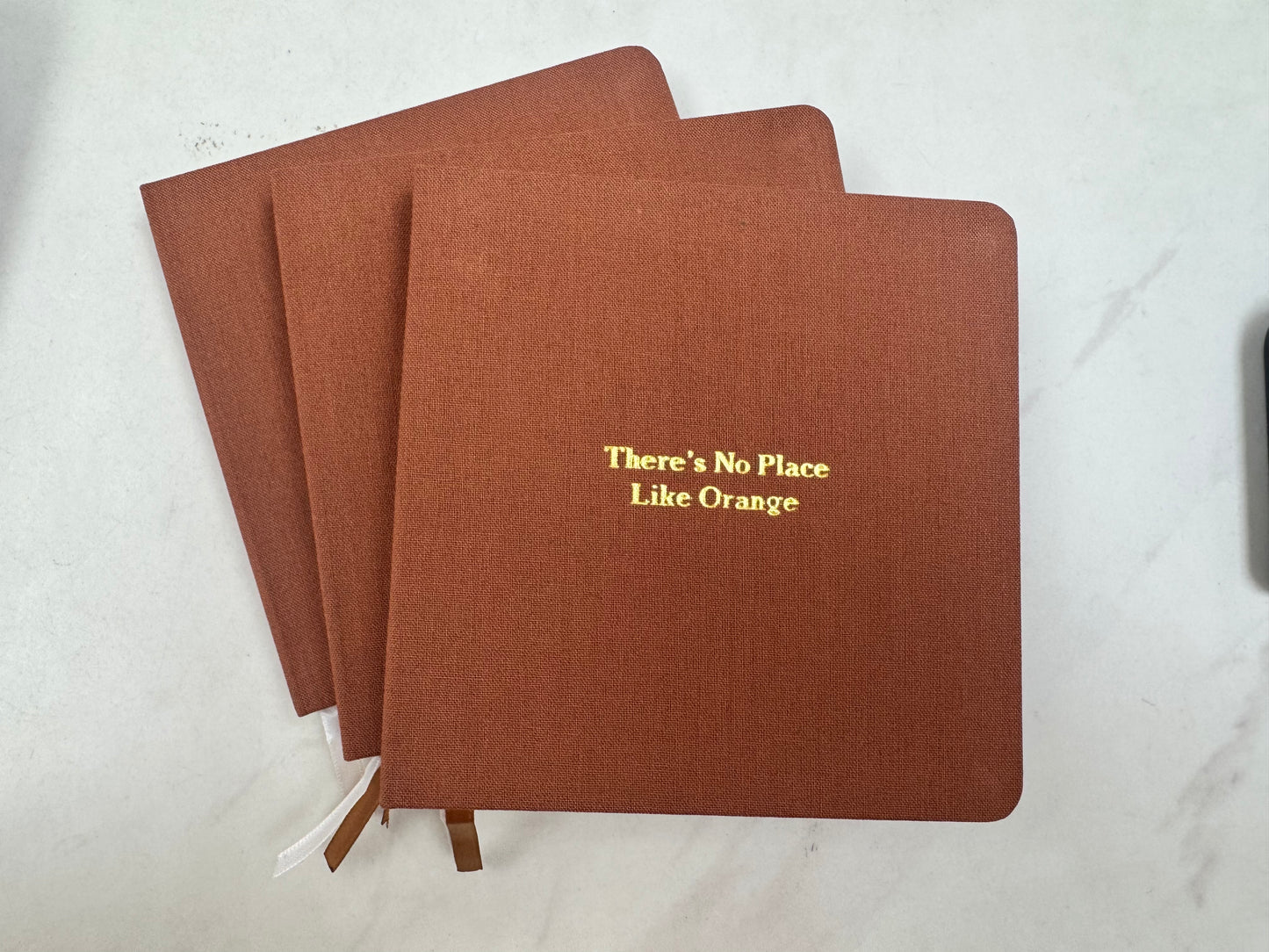 There's No Place Like Orange Foil Embossed Square Linen Notebook